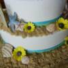 Close-up of the shells and flowers that we made out of fondant for this cake. 
To see more pics of this cake, please check out our Whisk Cake Company Facebook Page!