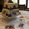 A 44th wedding anniversary cake. The cake is Red Velvet with a white chocolate ganache filling. The outside is covered in cream fondant with handmade roses and picture frames. Each frame is individually designed and piped using Royal Icing. 