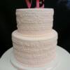 Close-up of the E.E. Cummings Poem piped on the cake in pale pink. 