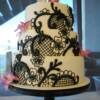 Close-up of the hand-piped black lace design piped onto this beautiful wedding cake. 