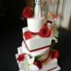 4 tier White and Red Wedding Cake with Fresh flowers and a Weddingstar Cake Topper.