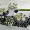Close-up of the cupcakes made for this wedding in 4 different designs and textures, as well as the black and white cake pops. Cake stands for the cake pops and cupcakes were supplied by Vintage Origami, while the Black stand that the cake is sitting on is available for rental from us!