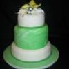 3 tiered Chocolate and Vanilla Bean sponge cake. Marbled green fondant showcases the larger middle tier. Hand made pearls make a perfect band around the base of each cake and show off the hand made Cala Lillies and rose buds that adorn the top.  