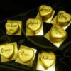 Miniature Gold wedding cakes. These heart shaped, gold cakes were painted with 24 kt. gold and then hand painted with the names of each guest on the cakes so that they could be used in place of their placecards. 