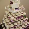 Purple and Ivory Cupcakes for a wedding at Sparkling Hill.
120 cupcakes sitting on our small cake tower with a round cutting cake. The cupcakes were a mixture of Red Velvet, Carrot Cake and Chocolate and Vanilla Chiffon Cake(with different colored cupcakes liners for each). 