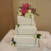 3 tier square silver wrapped wedding cake with fresh roses.