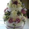 3 tier round Fresh Flower wedding cake with lilac ribbon.