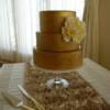3 tier Gold wedding cake with a sugar Peony.