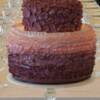 Pink/Purple Ombre Ruffle Cake. This cake was made with an 8" round top tier, and a 12" round double hieght bottom tier. We then added handmade gumpaste ruffles before coloring the ruffles in this Ombre Pink/ Purple color. 