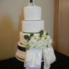 4 tier round White and Black textured cake with a large fondant bow draping down the front. Fresh flowers were supplied by Bramble Bush Florists in Vernon. 