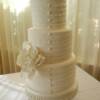 3 tiered (tall and skinny) victorian styled wedding cake. Elements on this cake included fondant ruffles, a hand-made sugar Gardenia and fondant buttons. 