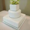 3 tier White and Silver wedding cake with a white-on-white monogram and sugar pearls.