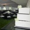 Our 3 tier square cake with the wedding reception set-up in the background. 