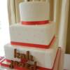 Close-up of the three tier Red & White Wedding Cake. 