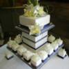 Navy Blue and diamond Miniature Wedding Cakes with an 8" cutting Cake.
3 different flavors of mini cakes surround the square cutting cake. We also made sugar orchids for this cake as well as macaroon gift boxes that were used as the name cards on the tables. 