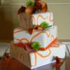 3 tiered Orange Squiggle Cake. This cake is covered in white fondant with orange fondant inlay. 