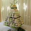 Green, White and Black Miniature Double Tier Wedding Cakes. 55 miniature wedding cakes sit on our small mini cake stand. On top of the stand was a 2 tier cutting cake