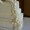3 tier White Hydrangea Wedding Cake. All of the hydrangeas were hand made sugar flowers, as well as the leaves. The bride supplied the cake topper. The cake is sitting on our 14 inch square cake stand that is available for rental.