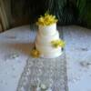 Yellow Cybidium Orchid with Pearl Banding Cake. We covered this cake in white fondant and painted a thick band of edible pearl on the base of each tier. We then added the Yellow Cymbidium Orchids to the cake upon delivery.
