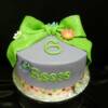 6th Birthday Party Cake with a green fondant bow and sugar daisies. 