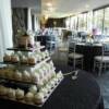 View of the Mini cake tower with the wedding reception set-up in the background. 