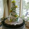 4 tier round Vine and Leaf cake with fresh green orchids.
