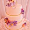 Close up of the sugar pansies made for this ivory and gold wedding cake.