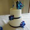 2 tier White-on white damask design wedding cake with fresh blue orchids.