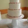 3 tier round wedding cake with different colored balls decorating the cake. 