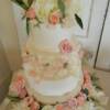 Fresh Flowers were added to the top,2nd and 4th tiers of this beautiful, Pale Pink cake. A lace design was added onto the third tier to help add to this vitage inspired wedding cake. 