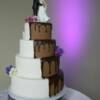 4 tier round wedding cake with half white, lace designs with edible pearls, while the other half of this cake was covered in chocolate fondant with melted chocolate ganache. Fresh flowers were added on delivery.