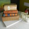 3-D Sculpted Books wedding cake for a book themed wedding. The bride supplied us with her favorite book titles, which we added to the spines of the books. Two mini Gluten-Free cakes were made and placed on the side of the cake for the gluten-intolerant guests.