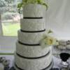 Close up of the 5 tier round Black and White Lace applique wedding cake. Fresh flowers were placed on the cake upon delivery.