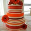 3 tier round Red and Orange Wedding Cake with fresh Gerbera Daisies