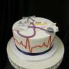 Nurse themed celebration cake for a graduate of the nursing program. Some details added to this cake include the heart rate on the side of the cake...