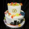 2 tier Celebration Cake- the top tier celebrated this couple's 50th Wedding Anniversary, while the bottom tier celebrated both of their birthday with items that they love to do (painting, travel, building).